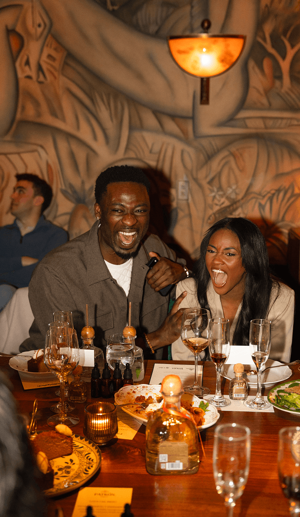 Guests laughing together at a Bulletpitch dinner